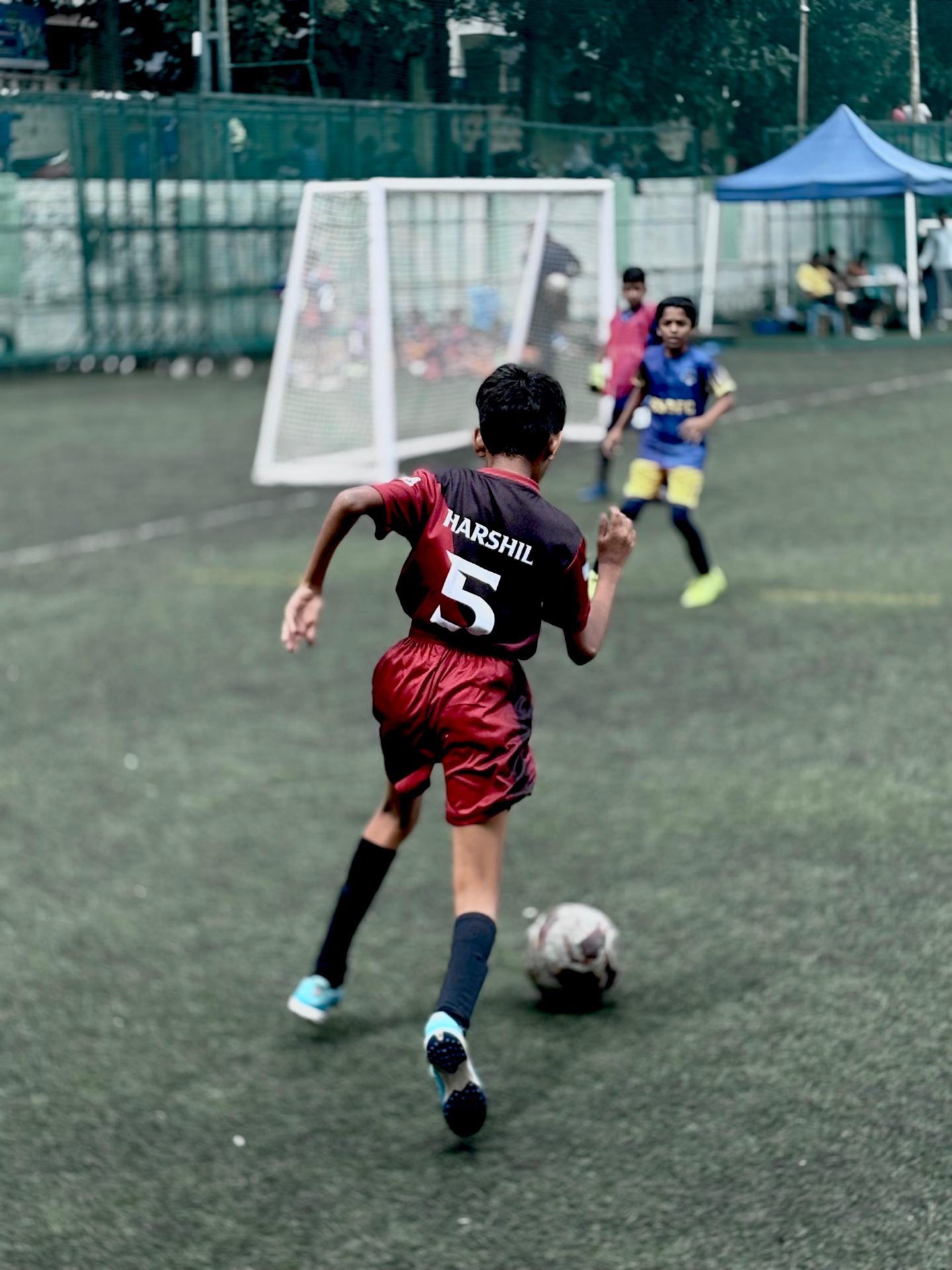 Harshil #5 driving toward goal